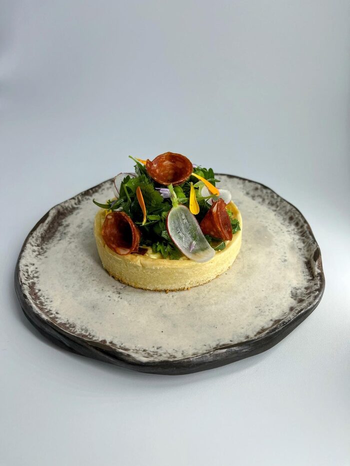 Spring savoury tart with peas, goat cheese and herb salad